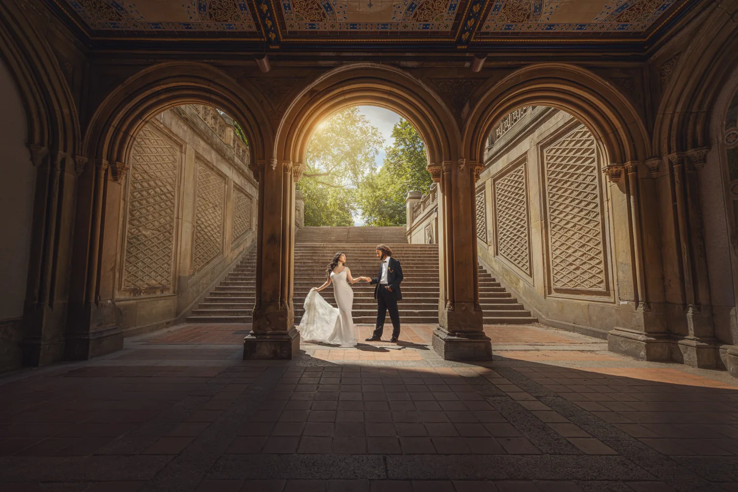 Bride and groom framed by the arcade arches at Bethesda Terrace in Central Park — George Pompilio Photography