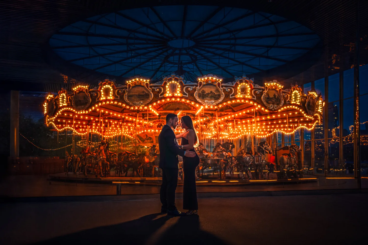 Couple dancing on the Brooklyn waterfront, her flowing red gown against the New York City skyline, engagement session by George Pompilio