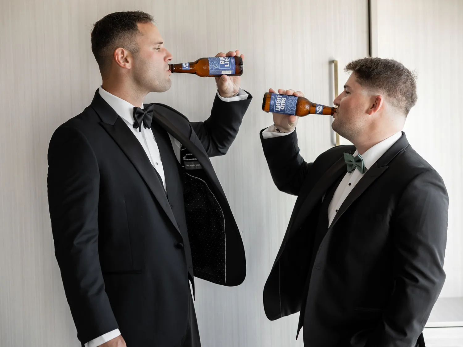 Luke sharing a beer with a groomsman while getting ready for his Gatsby On The Ocean wedding &mdash; George Pompilio Photography