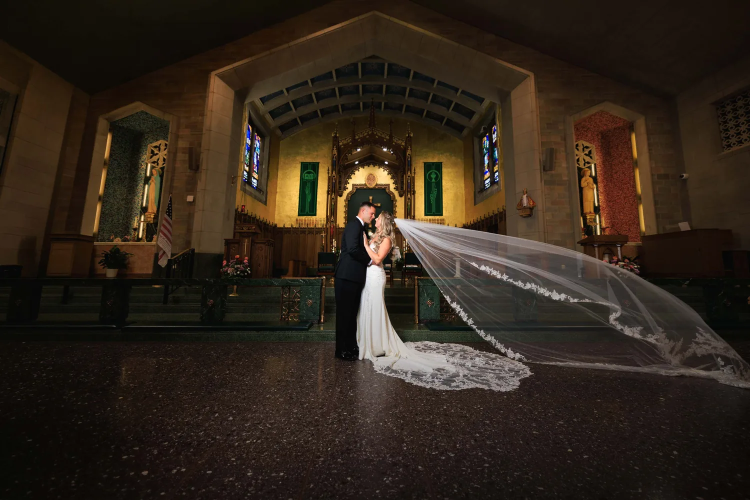 Allison and Luke with her cathedral veil spread across the floor inside The Church of St. Christopher &mdash; George Pompilio Photography