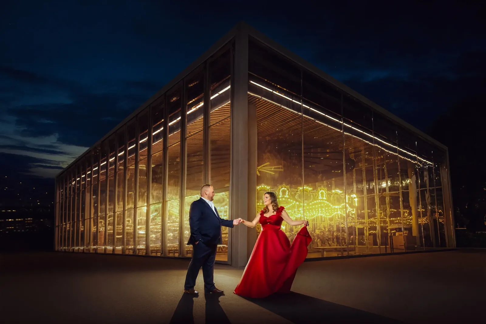 Engagement portrait in a red gown outside the glass pavilion of Jane&rsquo;s Carousel, Brooklyn &mdash; George Pompilio Photography