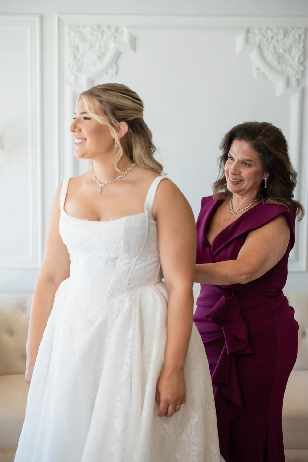 Chelsea and Ryan&rsquo;s wedding: Mother helping the bride into her gown at Larkfield &mdash; George Pompilio Photography