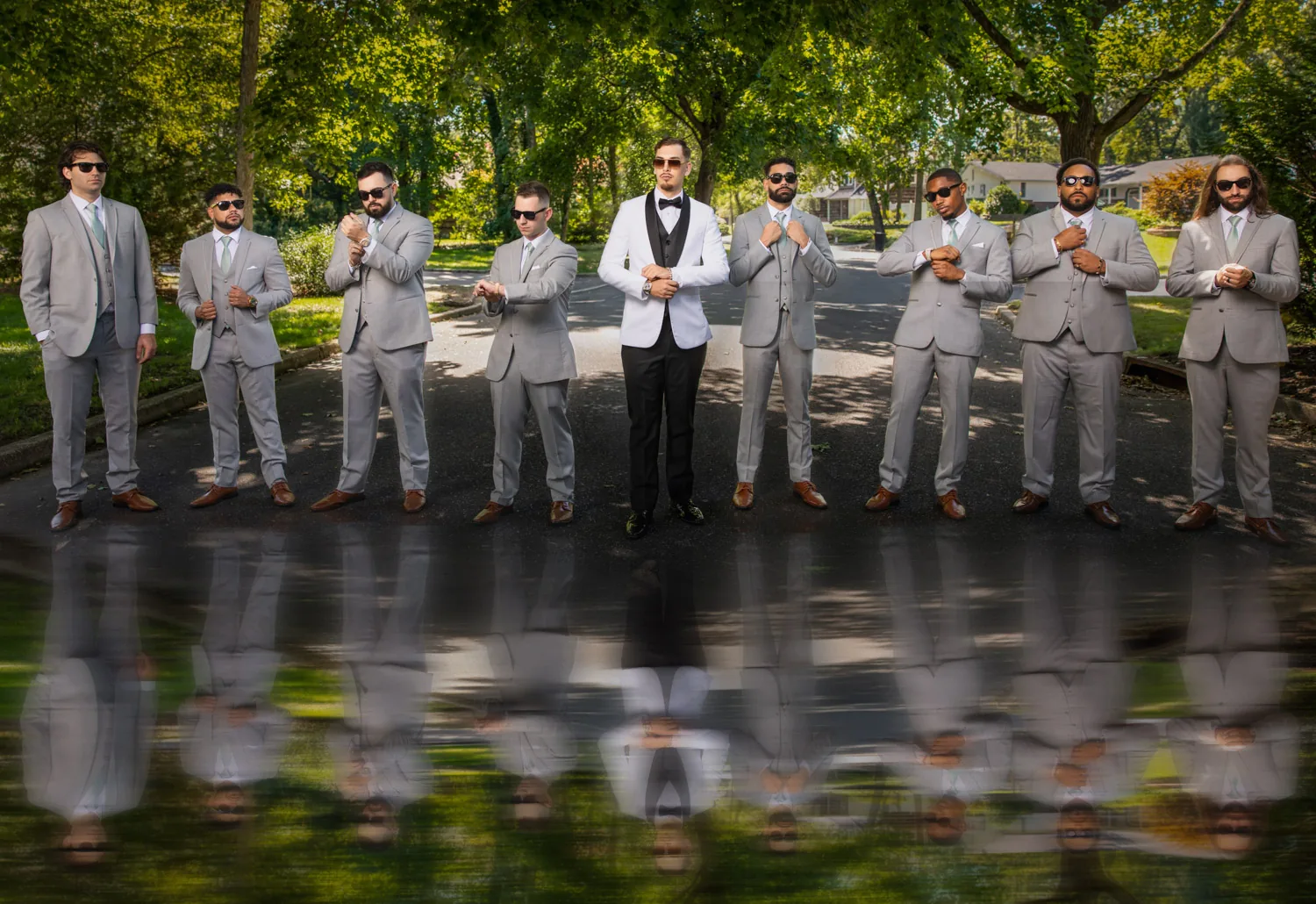 Chelsea and Ryan&rsquo;s wedding: Groomsmen reflected in water on the grounds at Larkfield &mdash; George Pompilio Photography