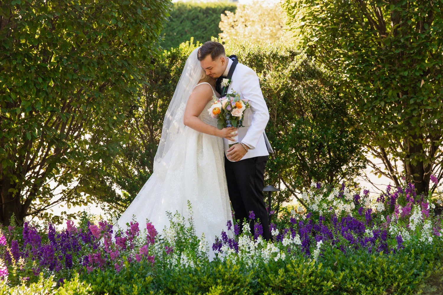 Chelsea and Ryan&rsquo;s wedding: Bride and groom embracing after the first look in the Larkfield gardens &mdash; George Pompilio Photography