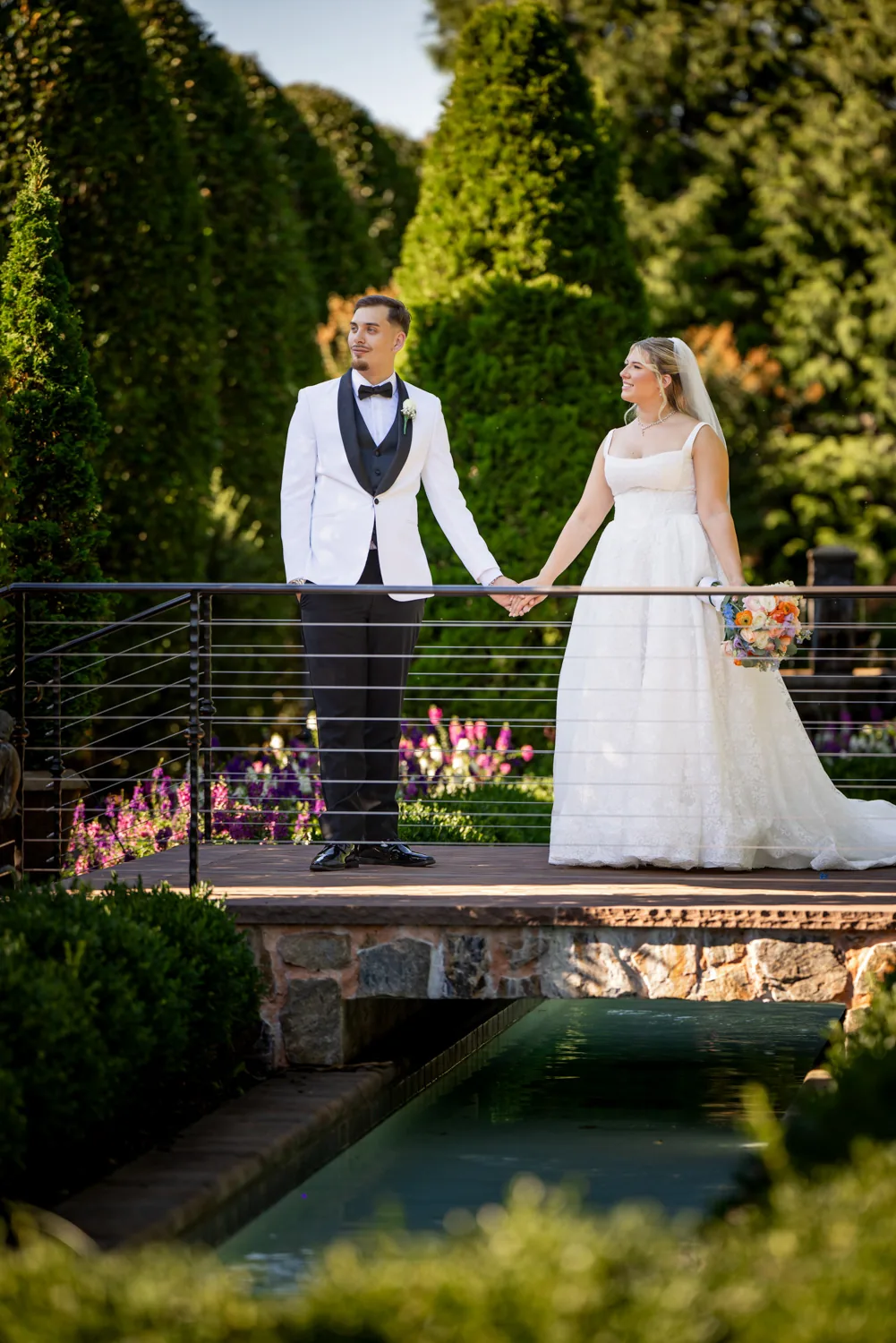 Chelsea and Ryan&rsquo;s wedding: Bride and groom on the bridge over the reflecting pool at Larkfield &mdash; George Pompilio Photography