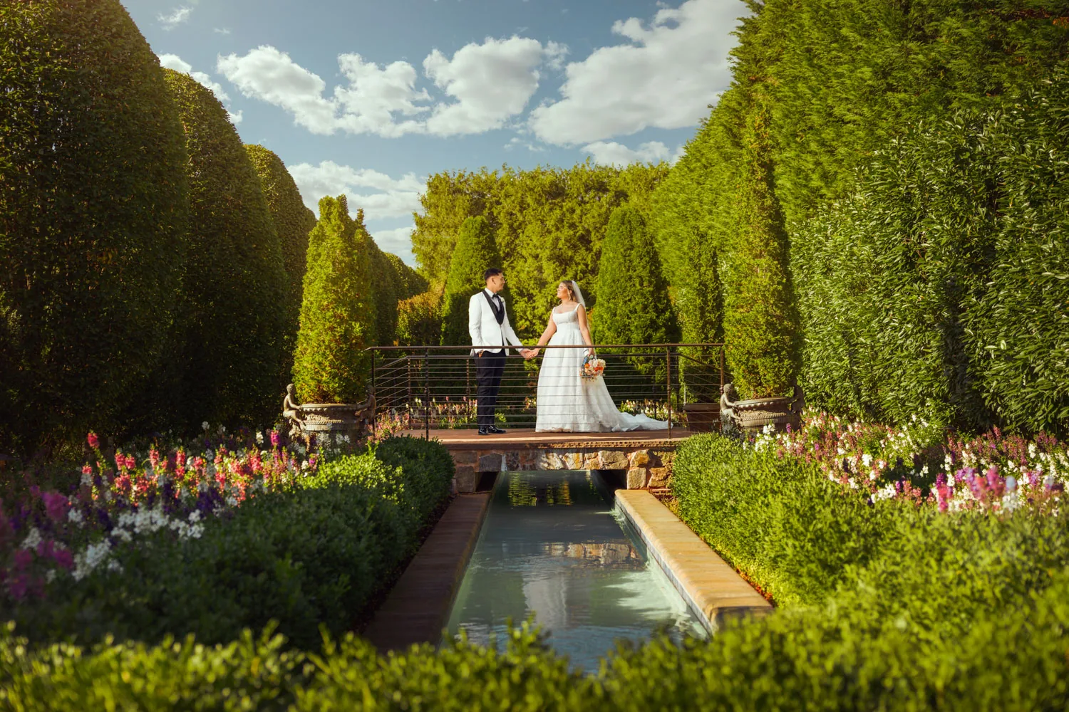 Chelsea and Ryan in the formal gardens and reflecting pool at Larkfield in East Northport, New York