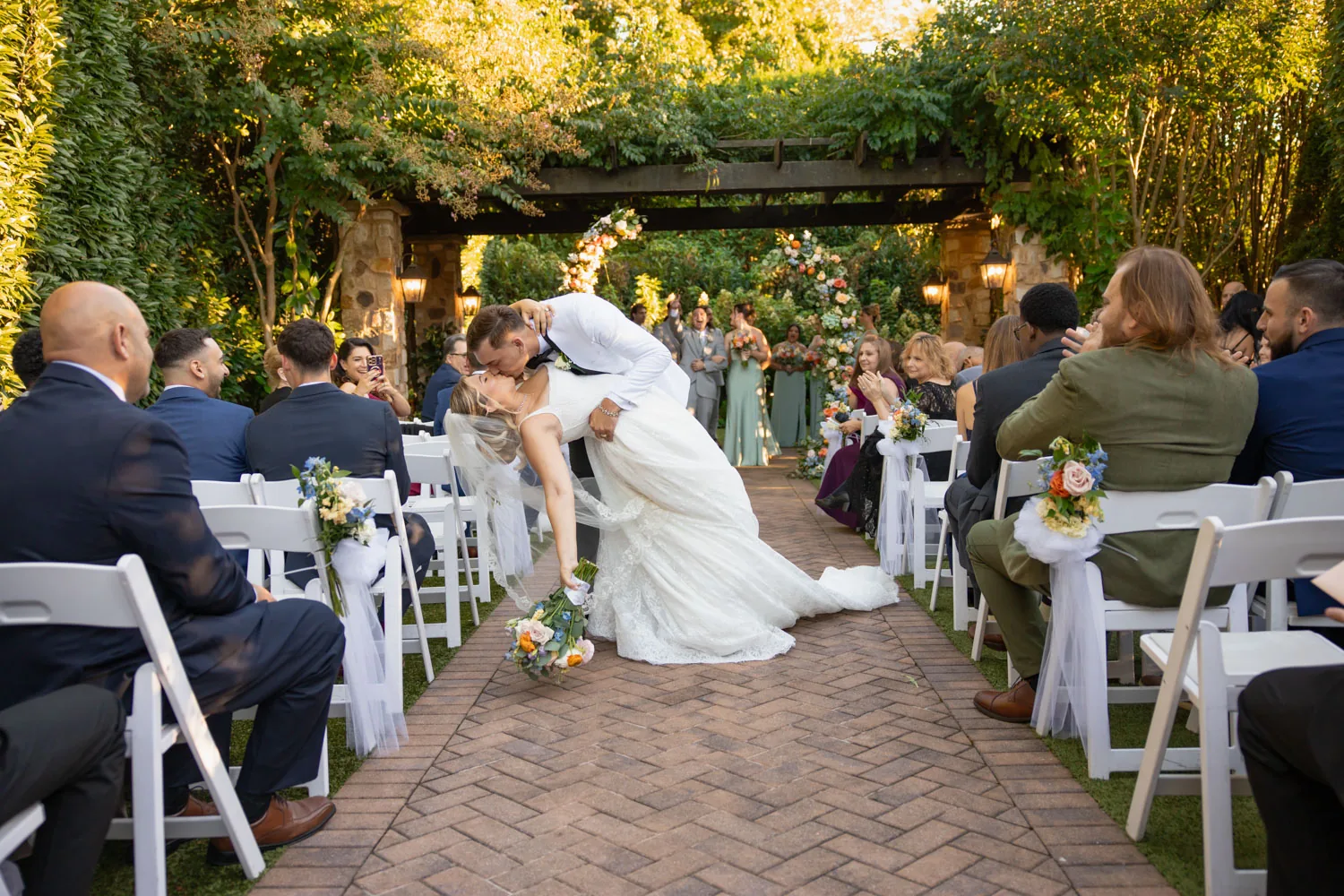 Chelsea and Ryan&rsquo;s wedding: Dip kiss down the aisle after the ceremony at Larkfield &mdash; George Pompilio Photography