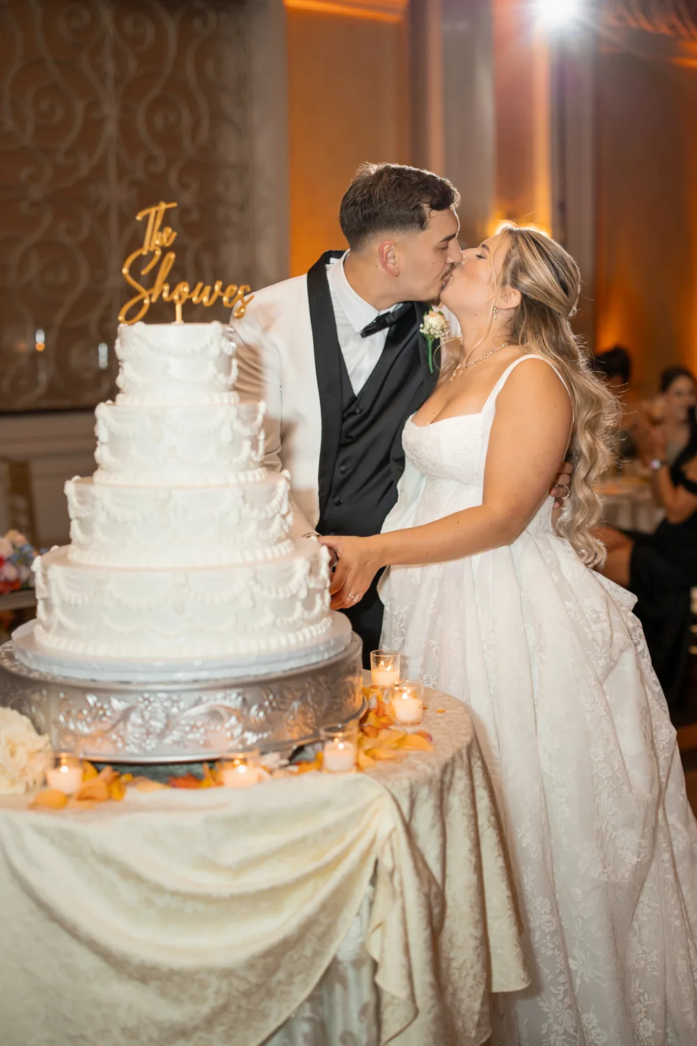 Chelsea and Ryan&rsquo;s wedding: Bride and groom kissing beside the wedding cake at Larkfield &mdash; George Pompilio Photography