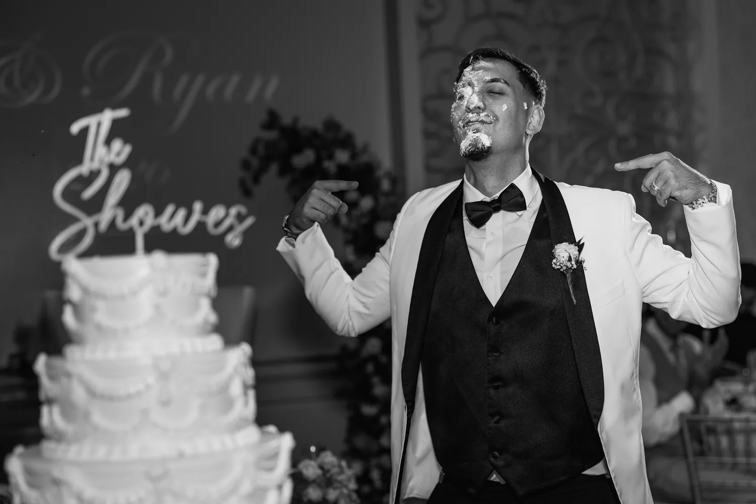 Chelsea and Ryan&rsquo;s wedding: Groom celebrating beside the wedding cake, black and white, Larkfield &mdash; George Pompilio Photography