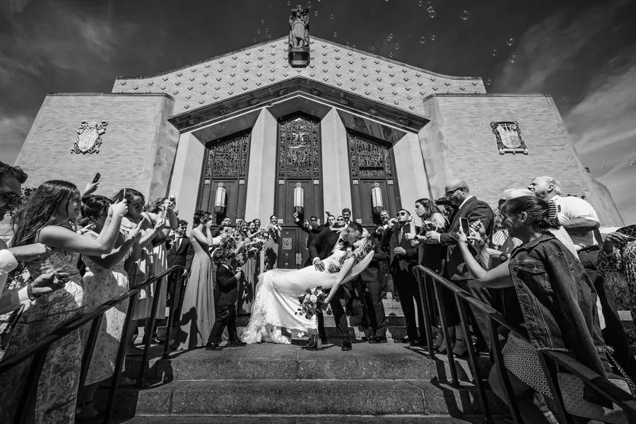 Bride and groom's celebratory exit outside St. Christopher Church in Baldwin &mdash; George Pompilio Photography