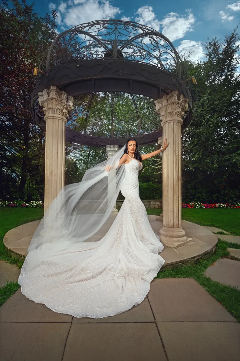 Bride with sweeping veil at an iron gazebo, by George Pompilio Photography
