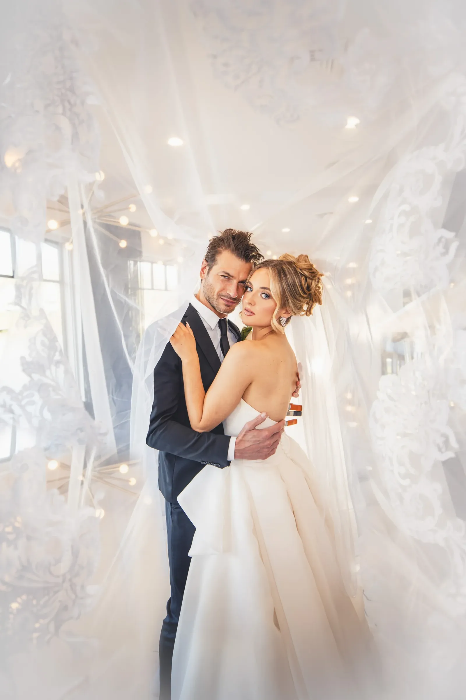 Bride and groom portrait with flowing veil and fairy lights — Modern Style, George Pompilio Photography